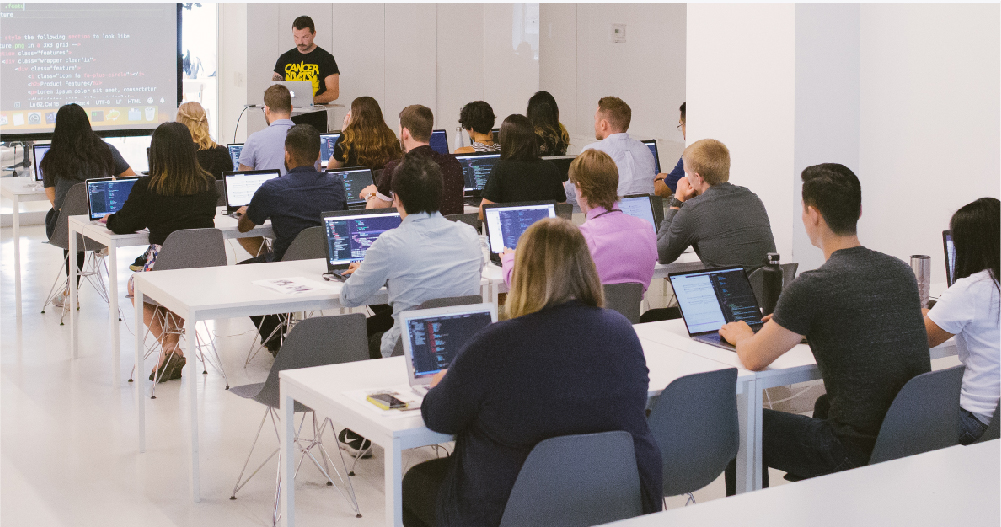 Instructor teaching a class full of students