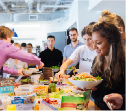 Students eating salad at a gathering at Juno college